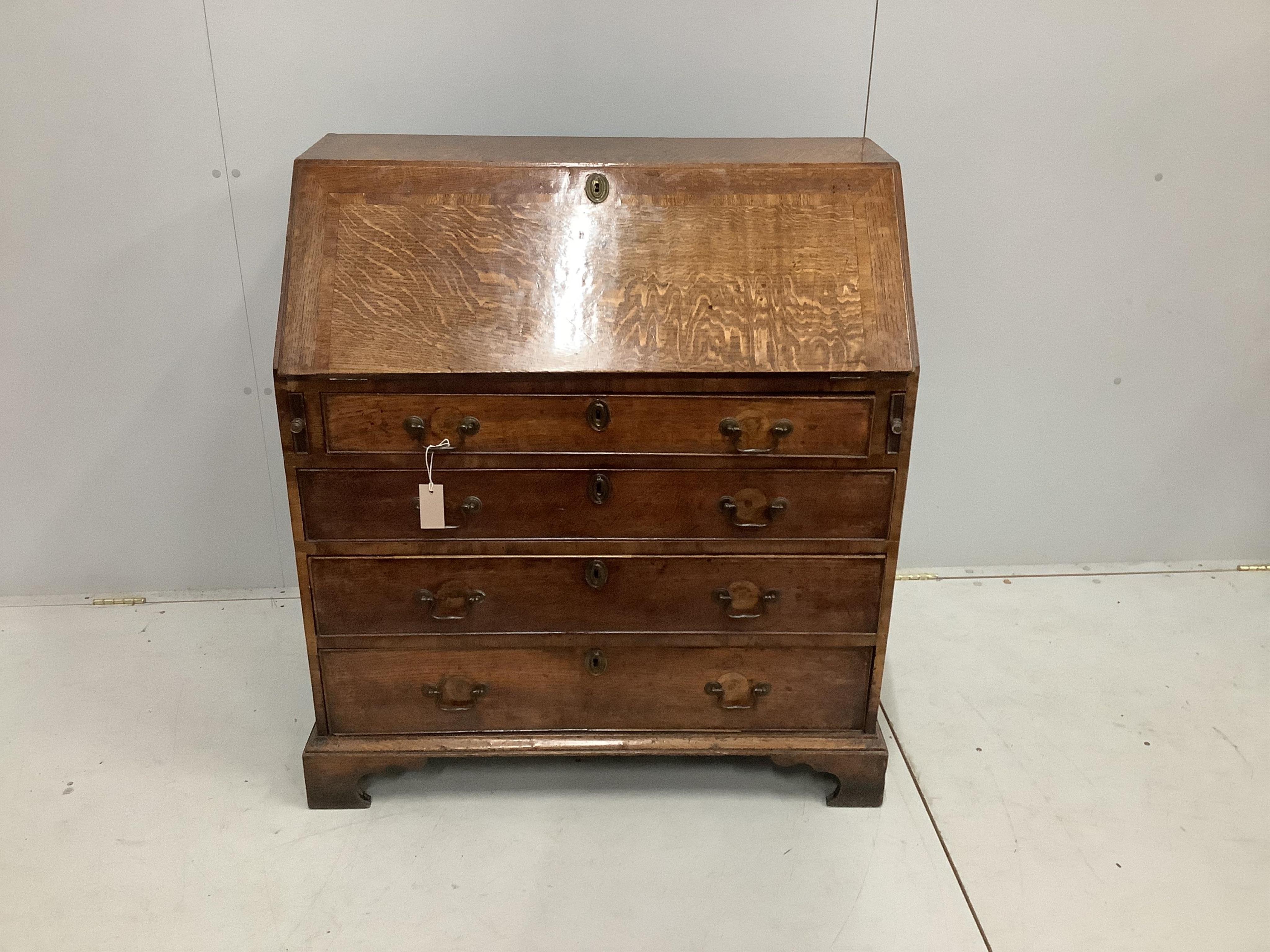 A George III oak bureau, with four long graduated drawers, on bracket feet, width 92cm, depth 50cm, height 100cm. Condition - fair